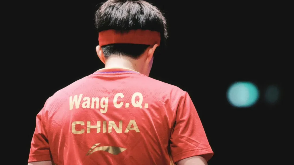 Wang Chuqin wearing red headband on the WTT table tennis court